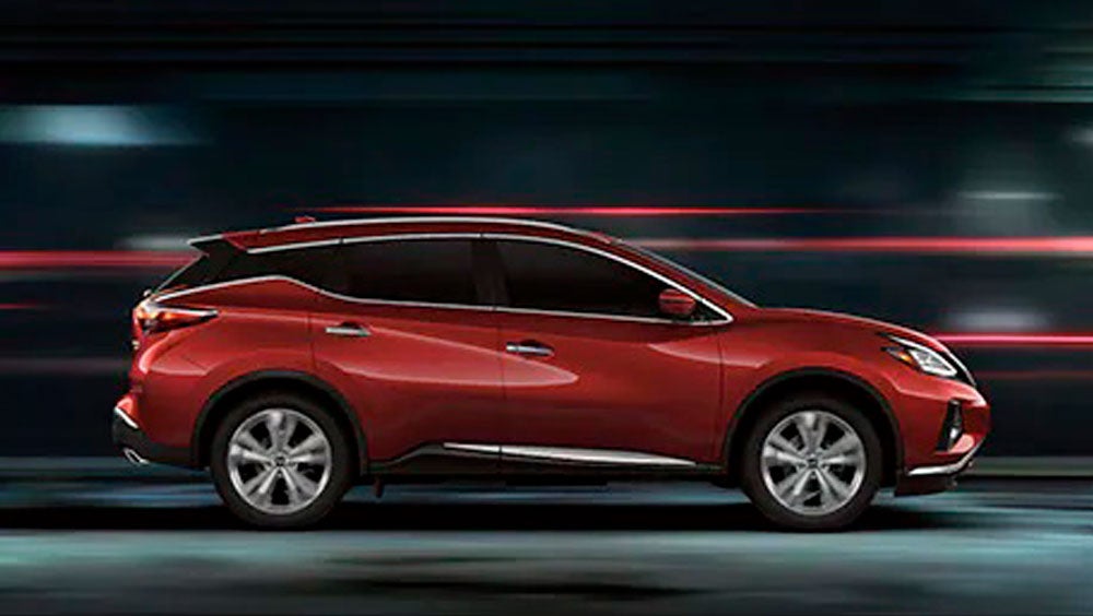 2023 Nissan Murano shown in profile driving down a street at night illustrating performance. | Coeur d'Alene Nissan in Coeur d'Alene ID